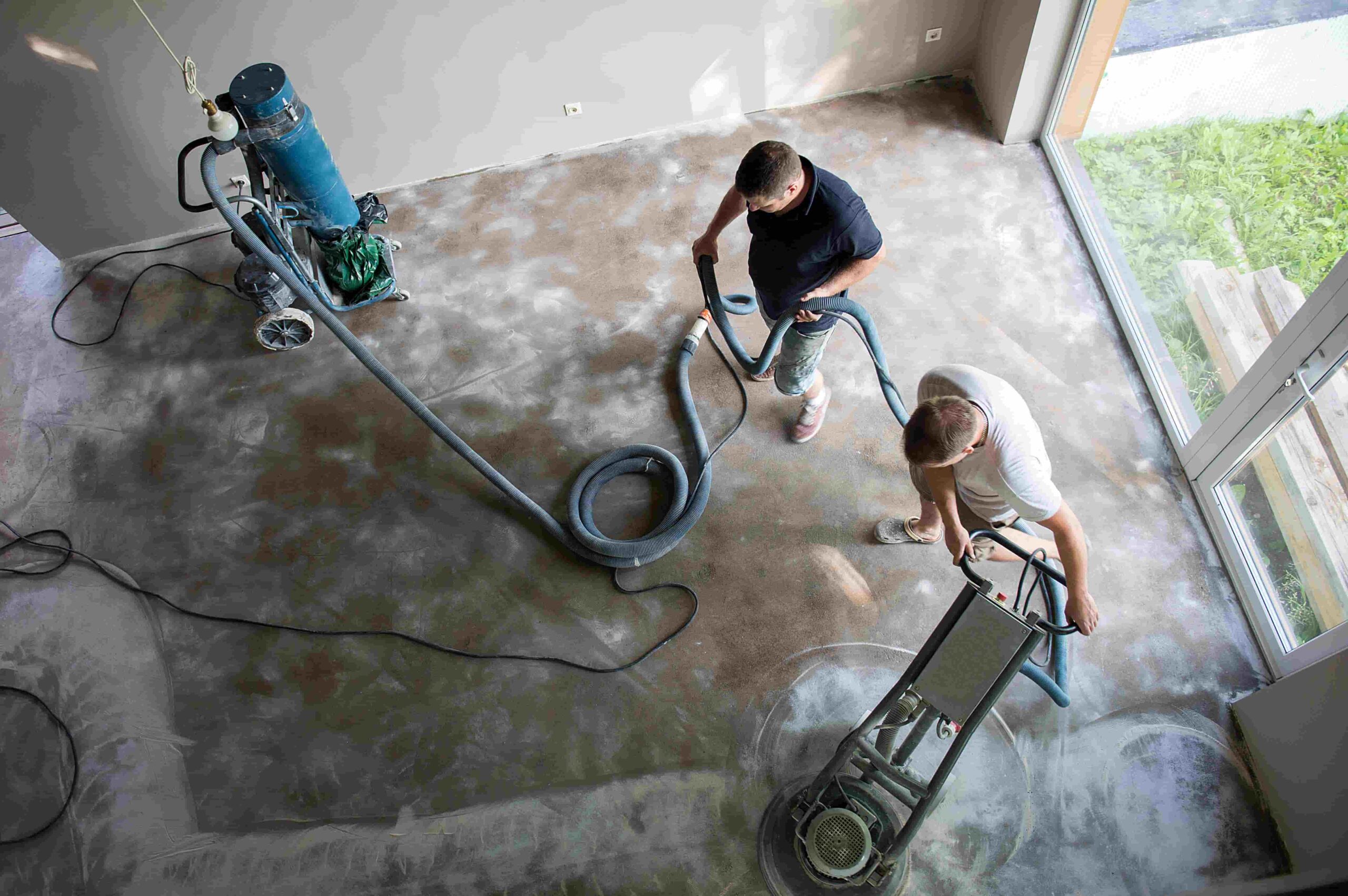 men smoothing concrete floor in room with tools 2026 03 20 01 59 13 utc