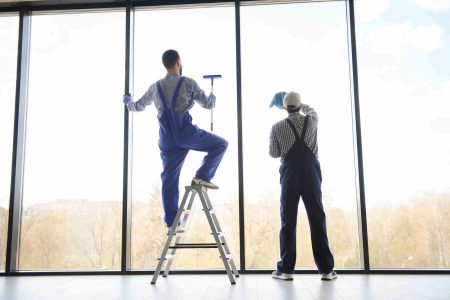 a man cleaning windows. cleaning team of men washes the windows